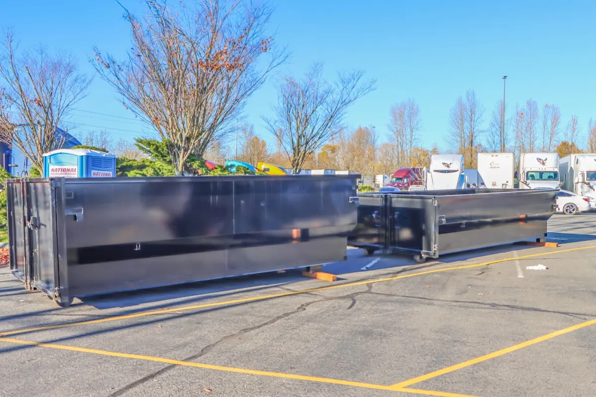 Professional dumpster rental service with roll-off container on residential driveway in Claymont